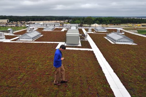 Man walks on green roof at Fort Bragg.